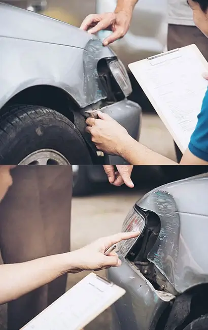 A person using a brush to clean the tire of a car.
